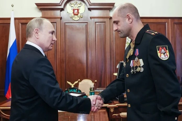 Russian President Vladimir Putin and DPR Armed Forces Lieutenant Colonel Artem Zhoga